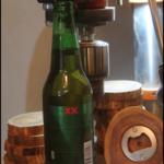 Wood coaster with bottle cap opener